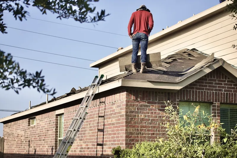 Professional roofer working on a residential roof in Glade Manor